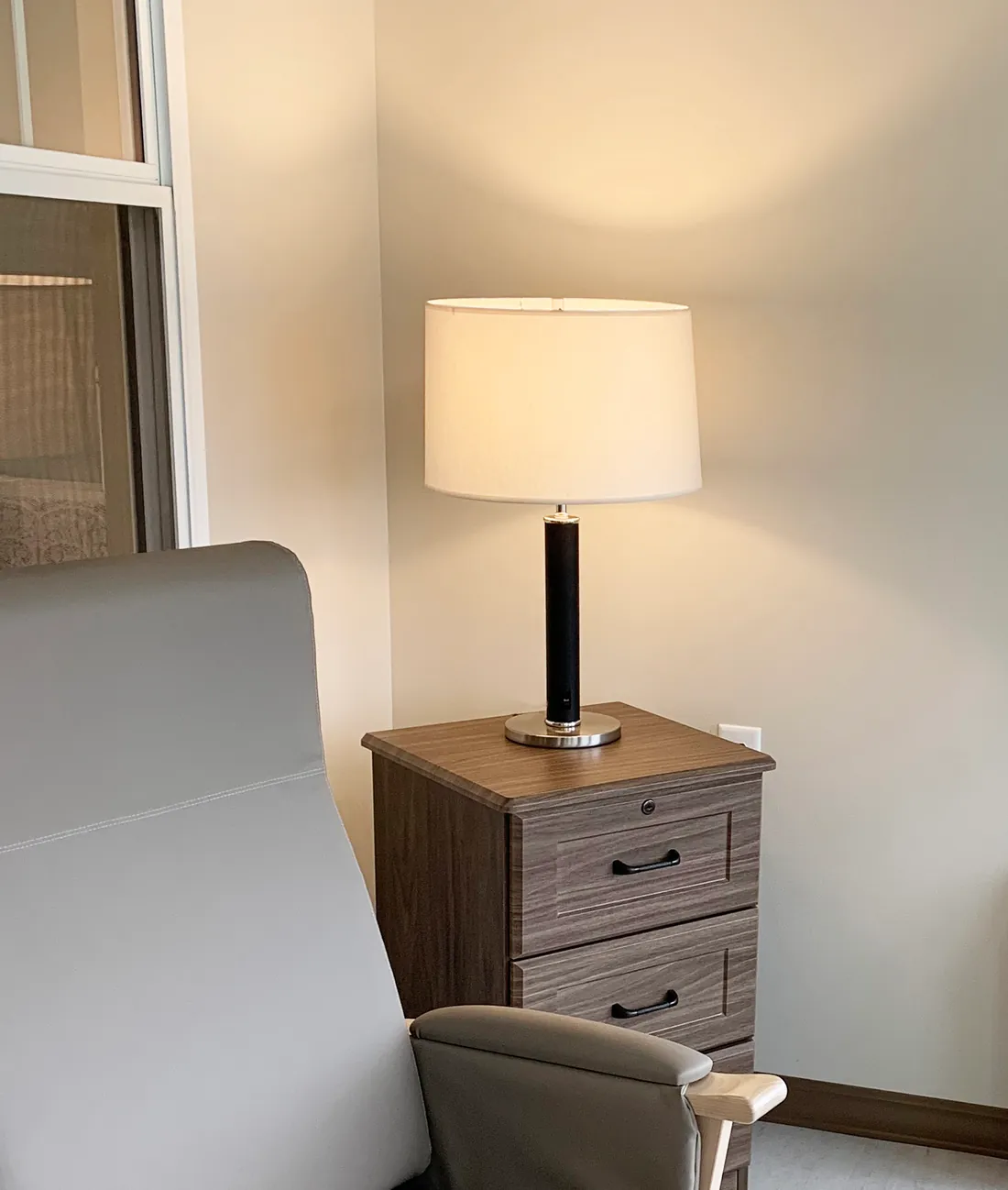 Multihousing room with JES lamp on nightstand